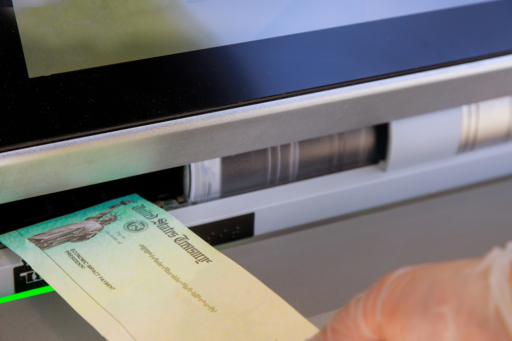  Stimulus checks being deposited in an ATM. 