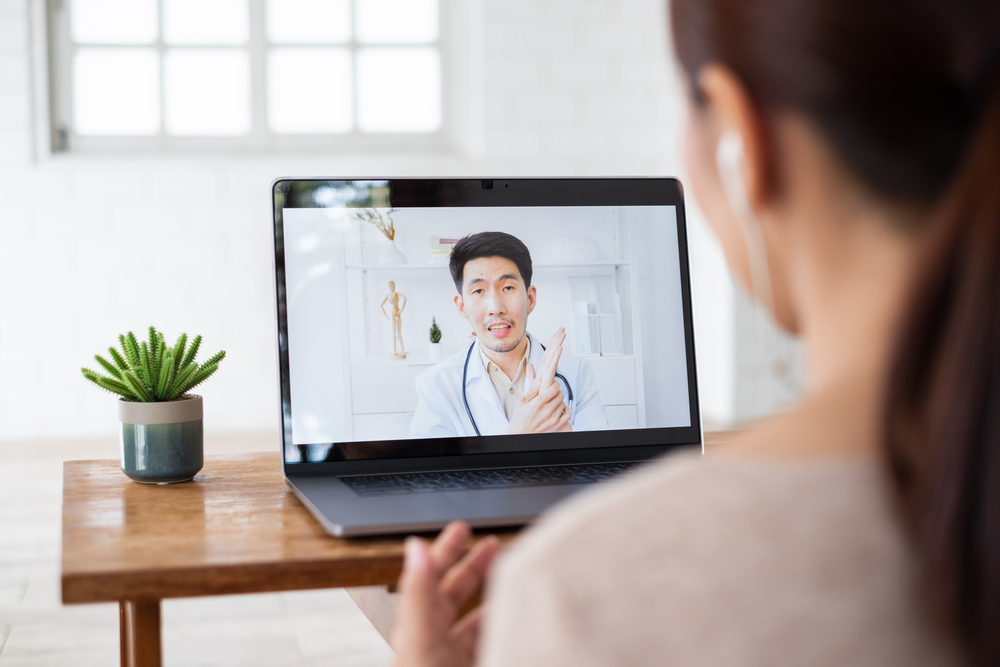 Asian,Woman,Talking,With,Doctor,Via,Computer,Laptop,Virtual,Video