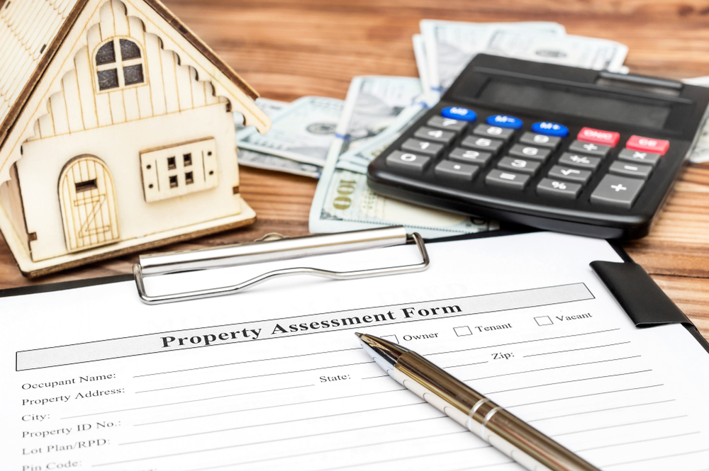 Property,Assessment,Form,With,Money,,Calculator,And,Model,Of,House