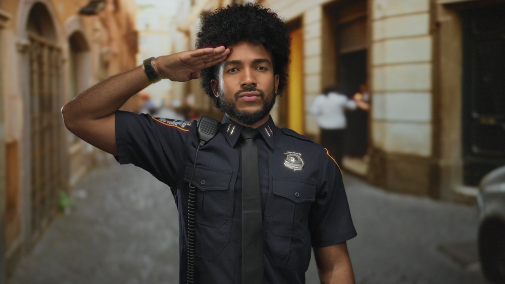 Police,Officer,Performs,A,Salute,On,A,City,Street,,Capturing